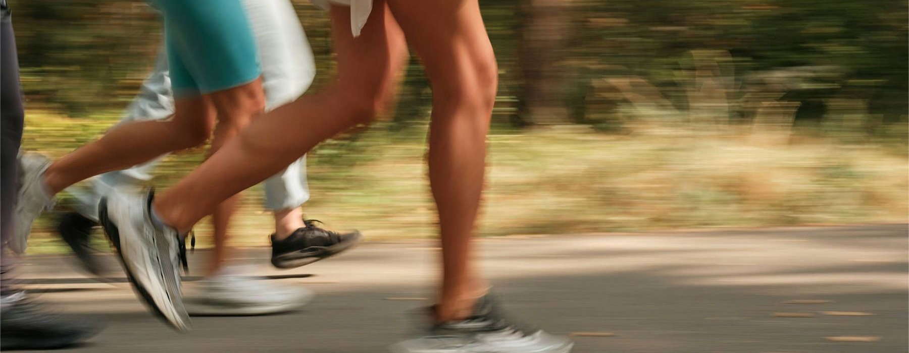 a group of people running on a road