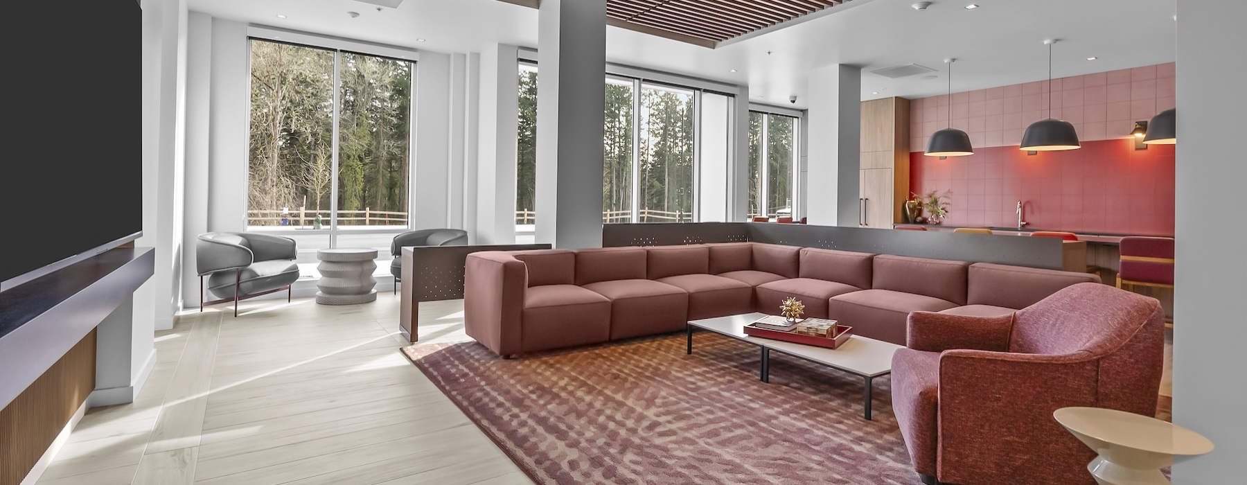 a lounge with a tv and a large couch