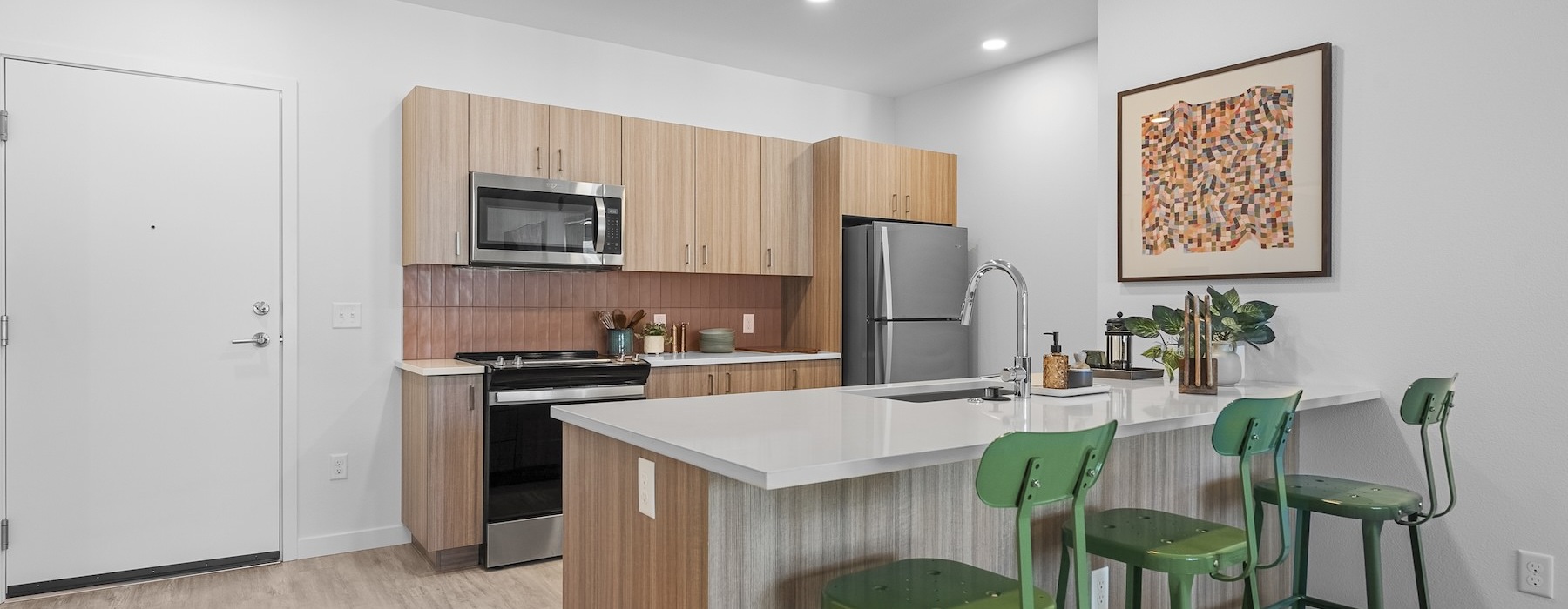 a kitchen with green chairs