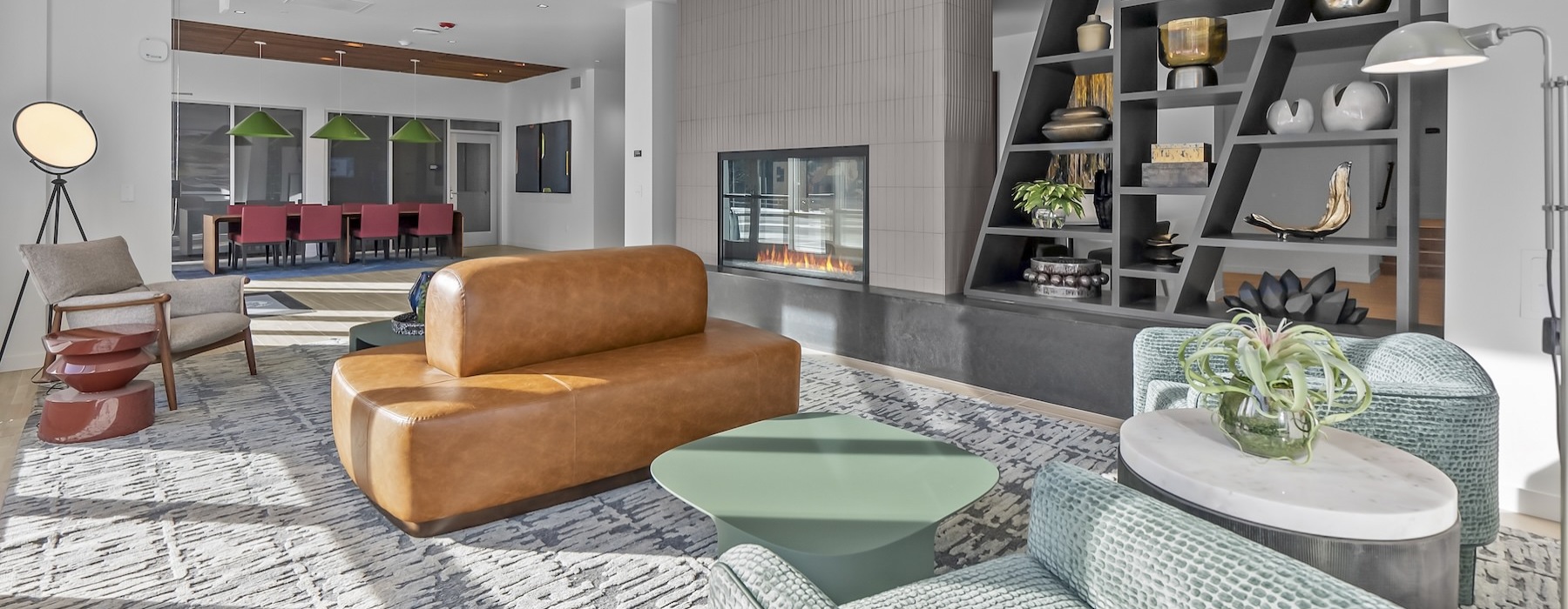 a clubroom with a couch, tables and chairs