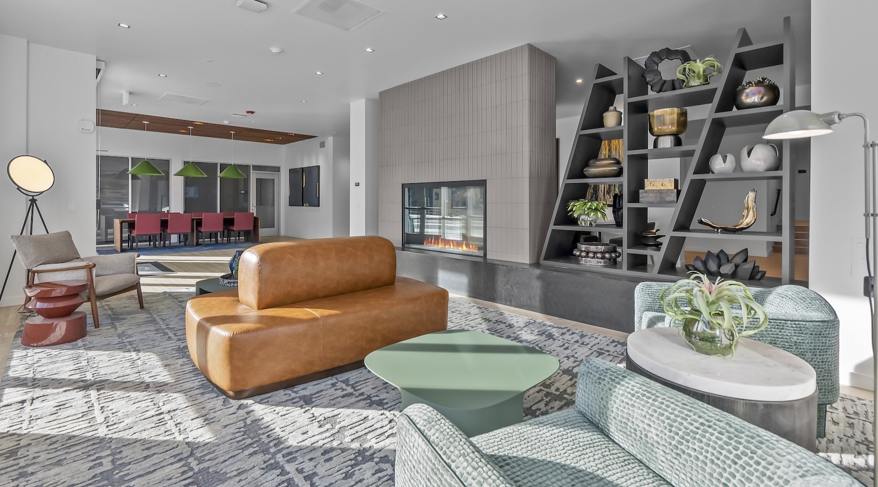 a clubroom with a couch, tables and chairs