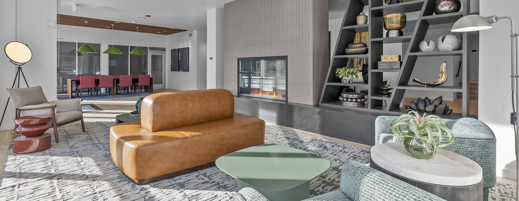 a clubroom with a couch, tables and chairs