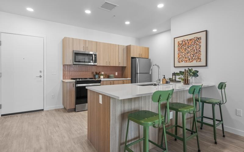 a kitchen with green chairs